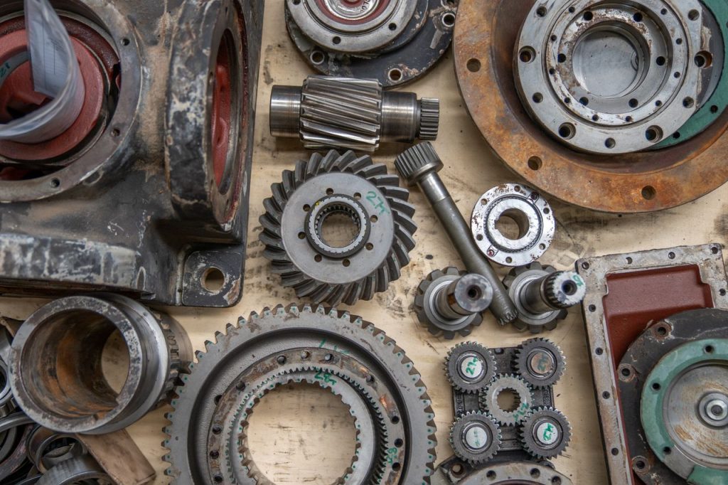 close-up-of-industrial-gears-and-mechanical-parts-28752152 Detailed shot of industrial gears and mechanical parts in a workshop setting.